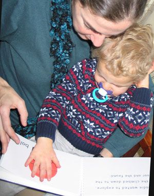 A child exploring the tactile pages of Sadie Can Count